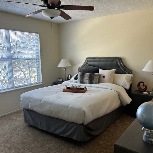 Bedroom with a fancy ceiling fan and a bed at MeadowView Townhomes in Goshen, Ohio
