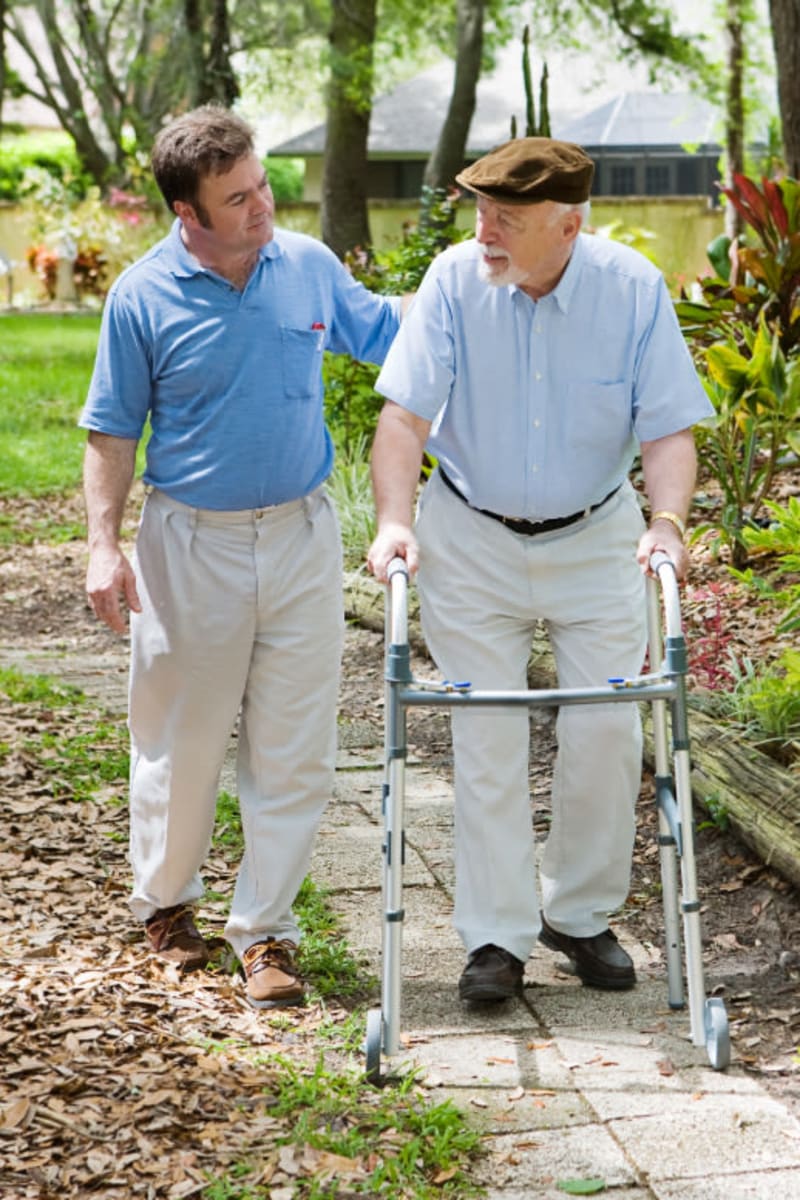 Resident enjoying a walk with their caretaker at Holton Manor in Elkhorn, Wisconsin