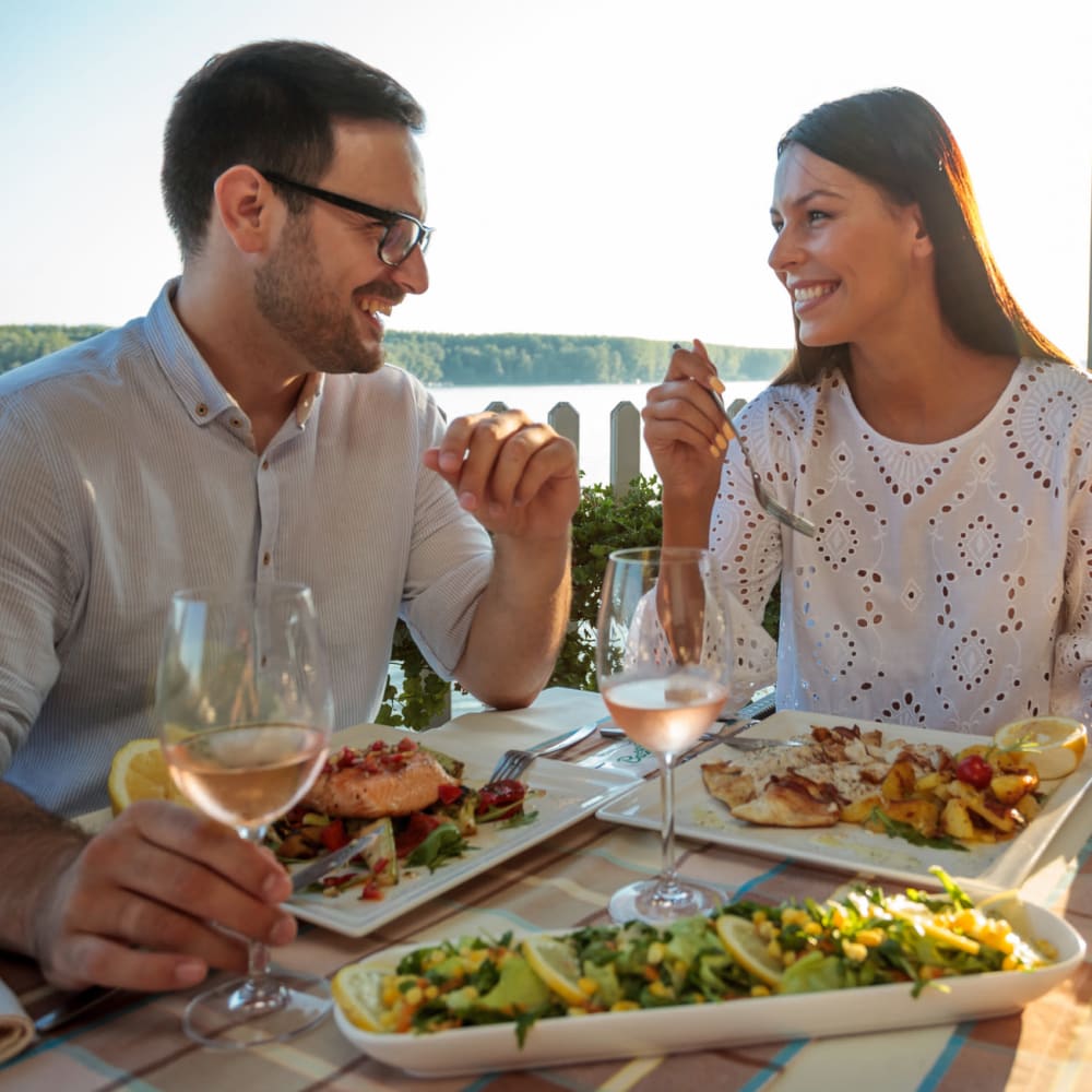 Couple enjoying harborside dining at one of the restaurants at Portside Ventura Harbor in Ventura, California