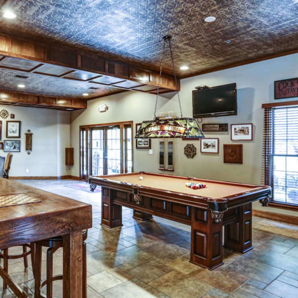 Resident clubhouse with pool table and table top built in chess boards at London House Apartments in Lenexa, Kansas