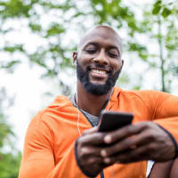 Man on his phone outside near Town Center Apartments in Lafayette, California