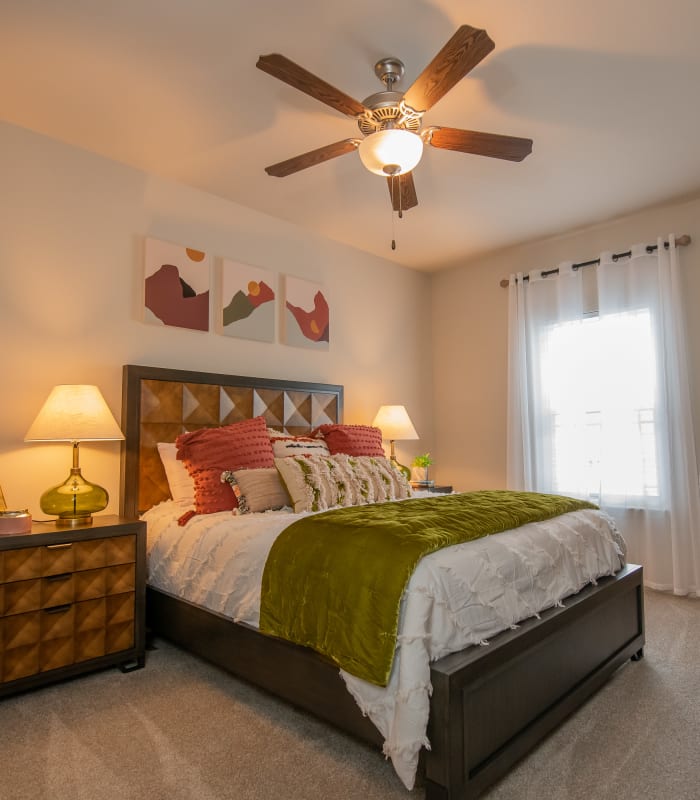 Chic bedroom with ceiling fan at Bend at New Road Apartments in Waco, Texas