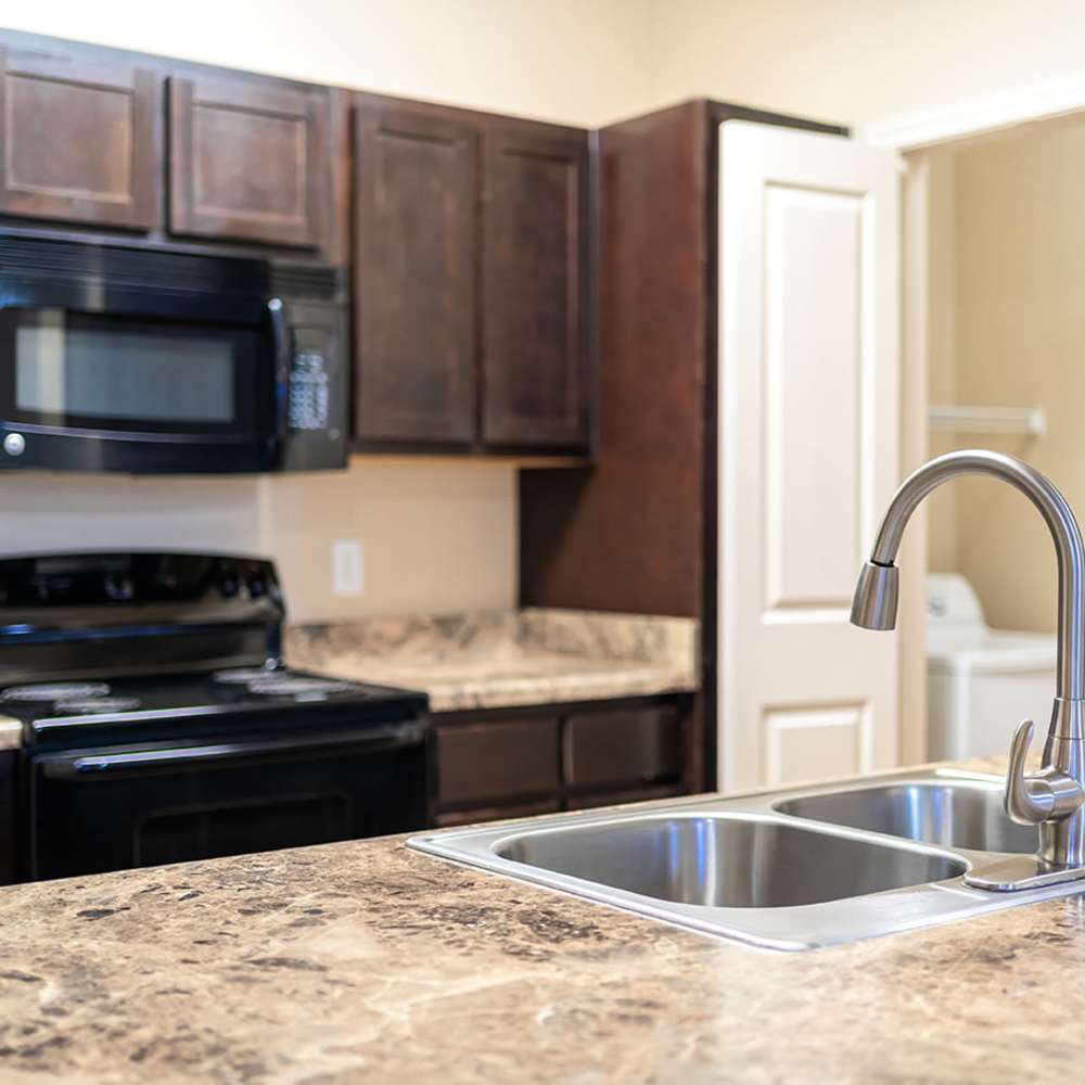 Kitchen with stainless-steel appliances at Sunset Lodge in Odessa, Texas
