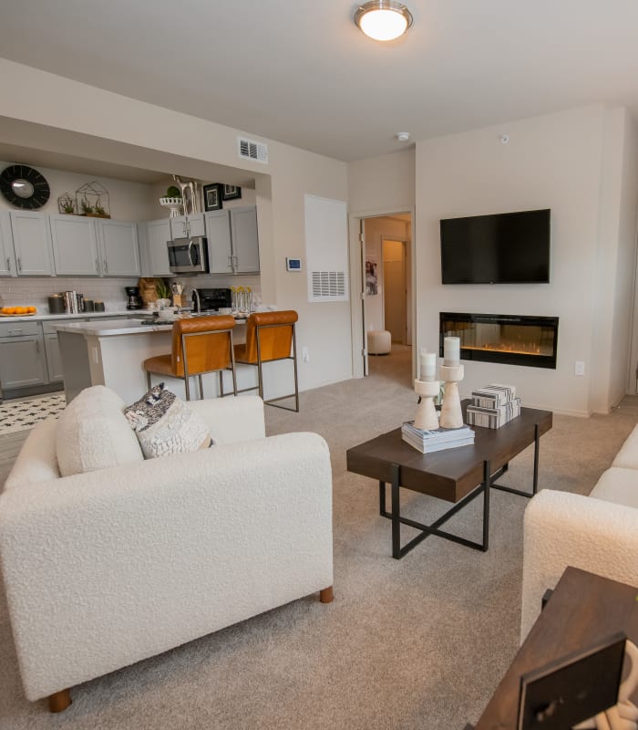 Carpeted living room at Bend at New Road Apartments in Waco, Texas