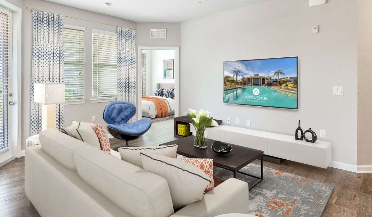 Cozy living room with large flat screen tv at Art Avenue Apartment Homes in Orlando, Florida