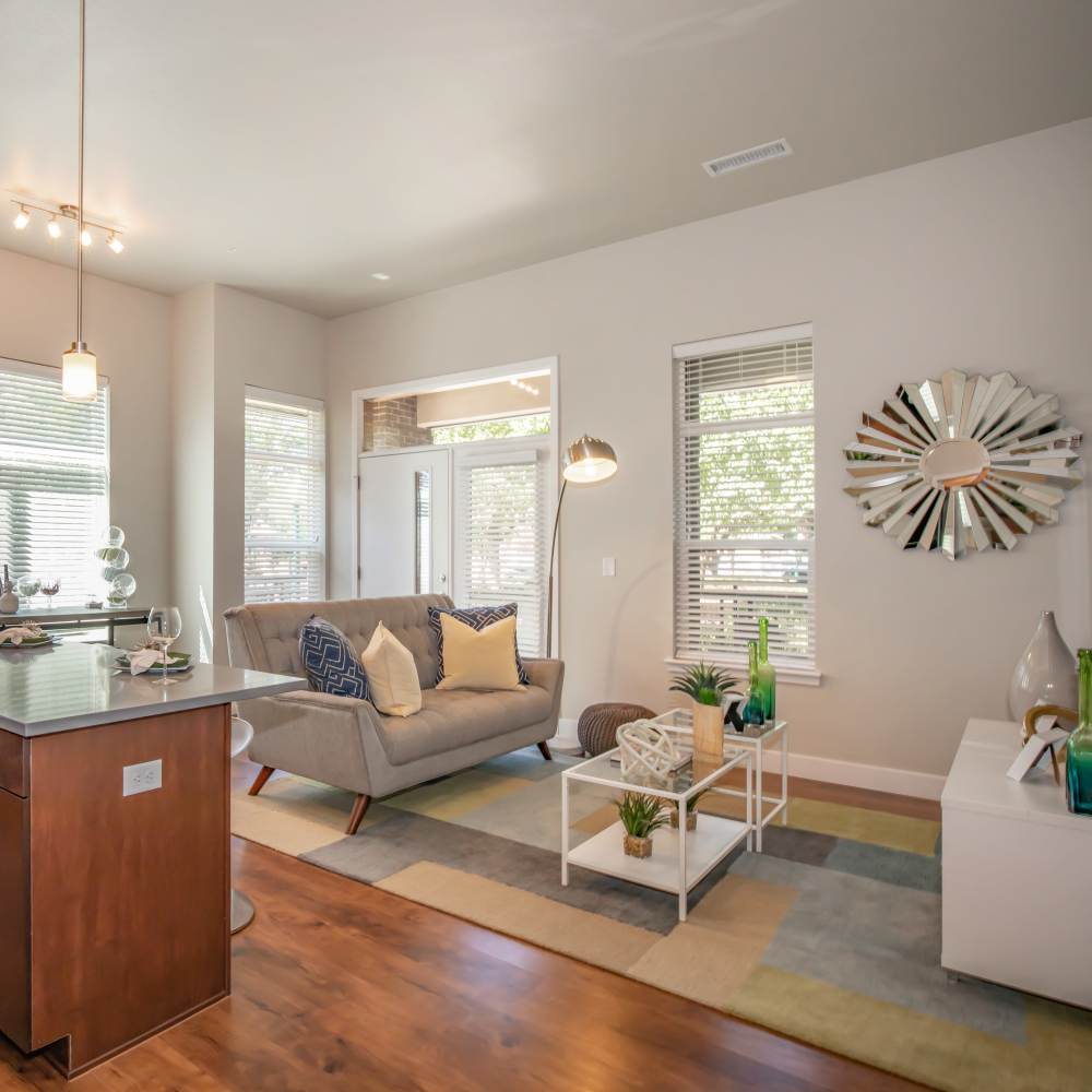Spacious ;living room with large couch, coffee table and carpet at Park Place Olde Town Apartments in Arvada, Colorado
