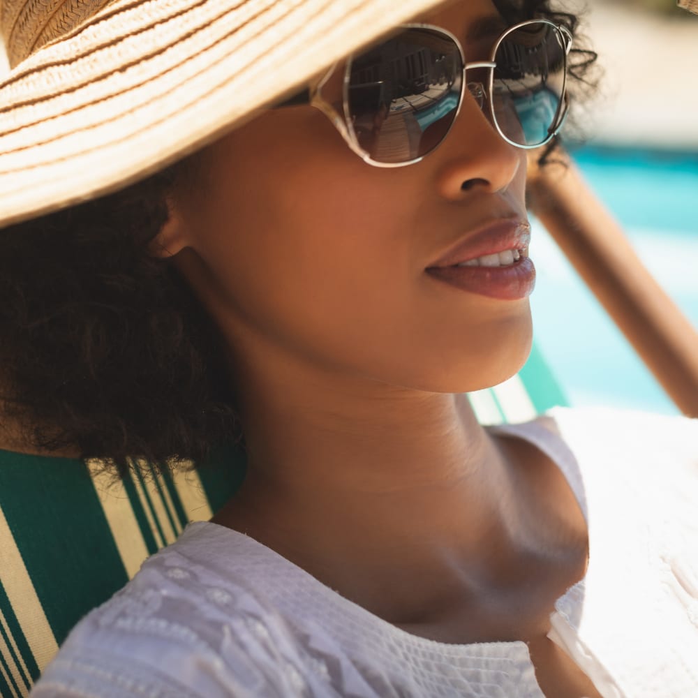 Resident relaxing by the pool at Cantabria at Turtle Creek in Dallas, Texas