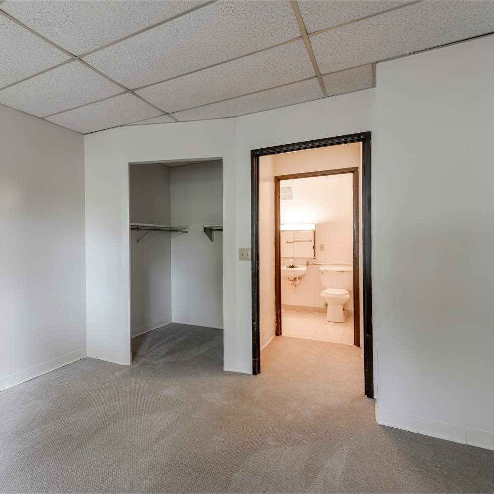Bedroom with connected bathroom and closet at Burton Place in Burton, Michigan