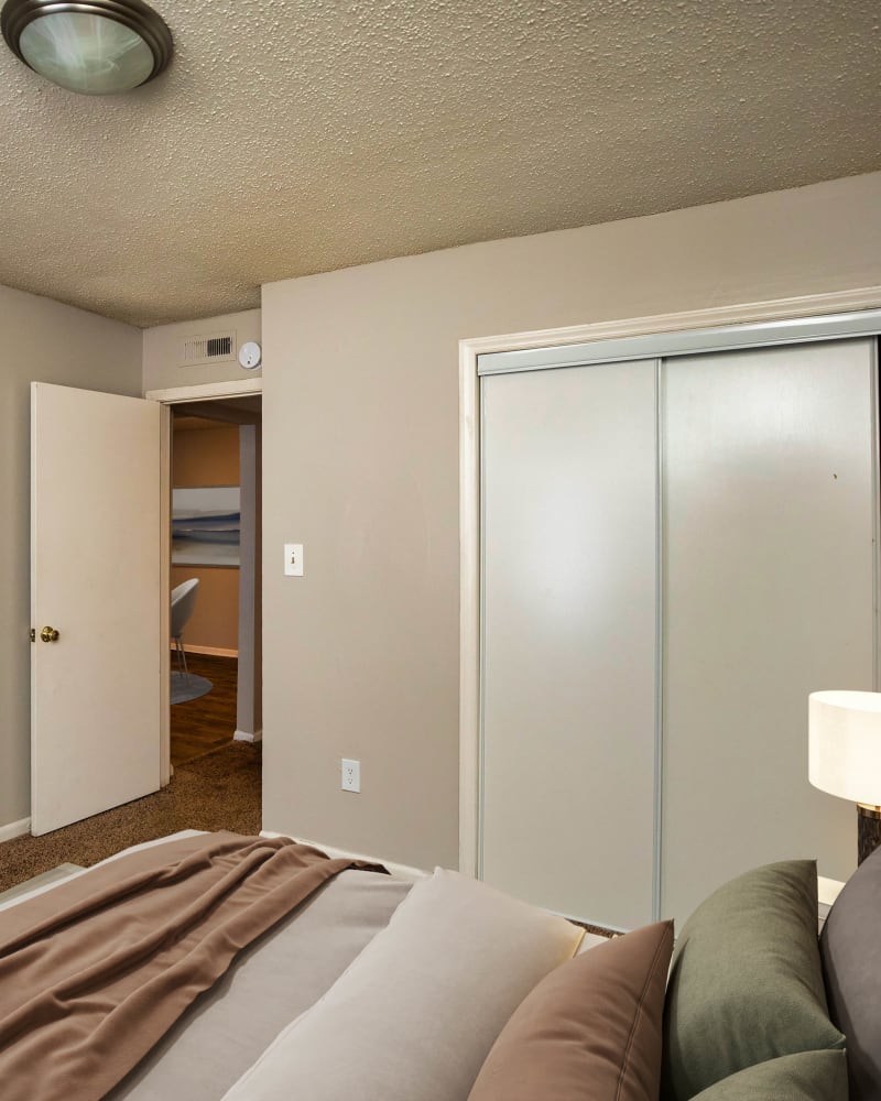 A large bed in a model apartment bedroom at Magnolia Manor Apartments in Center Point, Alabama