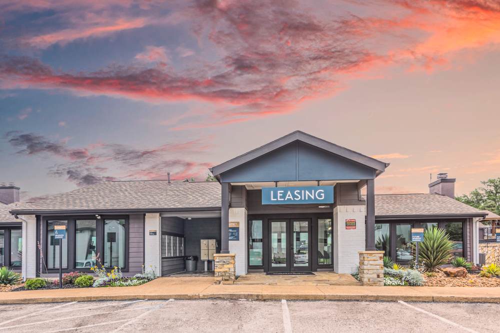 Building exterior at dusk at Barrett Apartment Homes in Garland, Texas