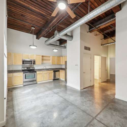 Unfurnihed living room with concreate flooring at Stadium Loft Apartments in Saint Louis, Missouri