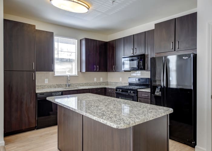 Well-decorated living room and dining area in model townhome at Prynne Hills in Canton, MA