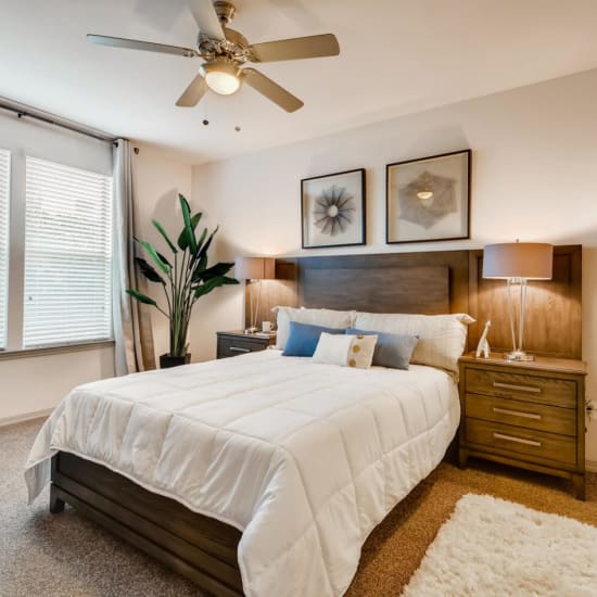 Bed and nightstand in a model home's bedroom at Discovery at Craig Ranch in McKinney, Texas