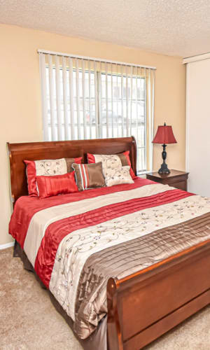 Model bedroom with plush carpeting at River Ranch in Sherman, Texas