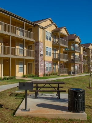 Picnic bench with grill area at Mission Point Apartments in Moore, Oklahoma