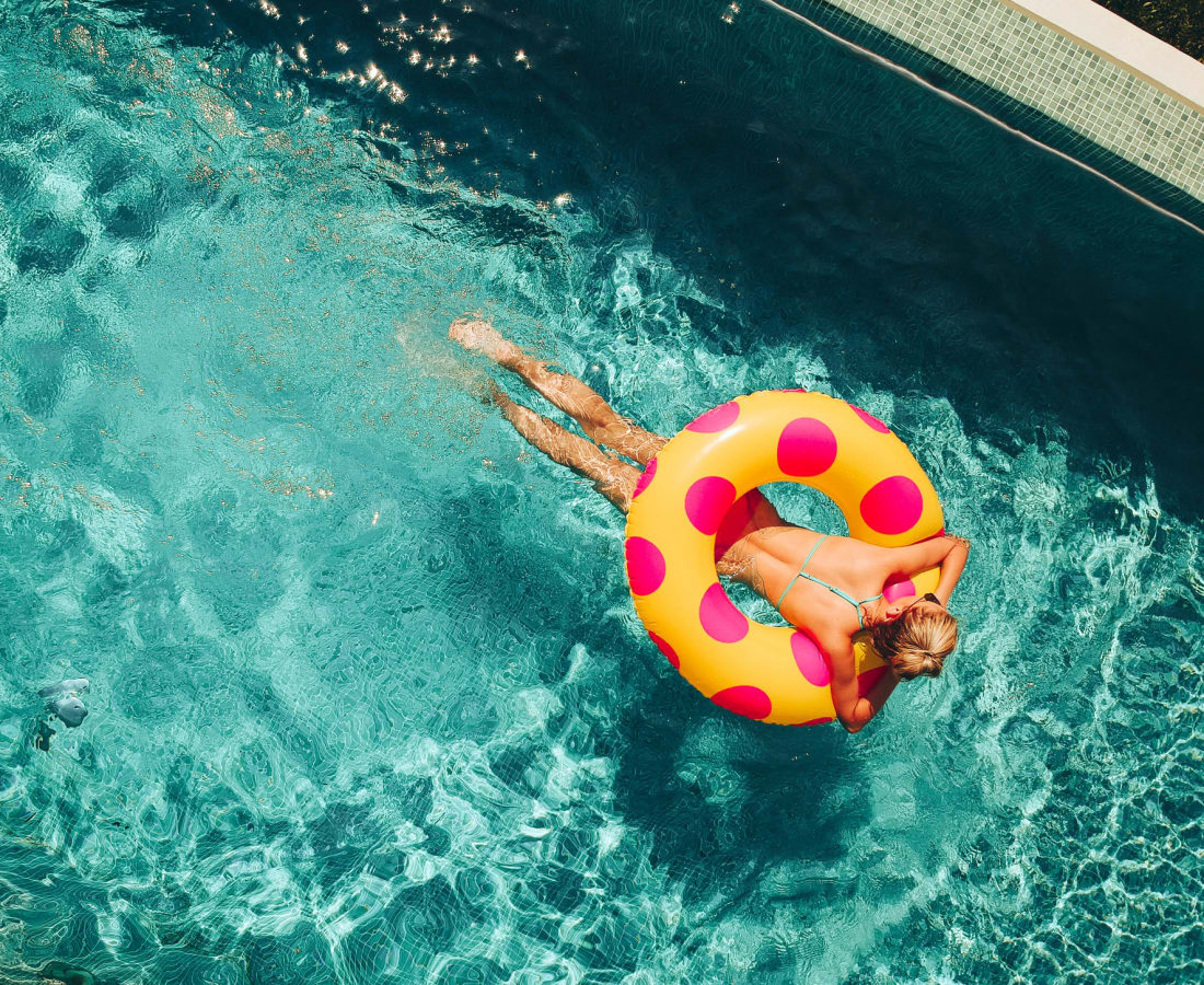 Resident floating in the pool at Hamlet at MidCity in Huntsville, Alabama