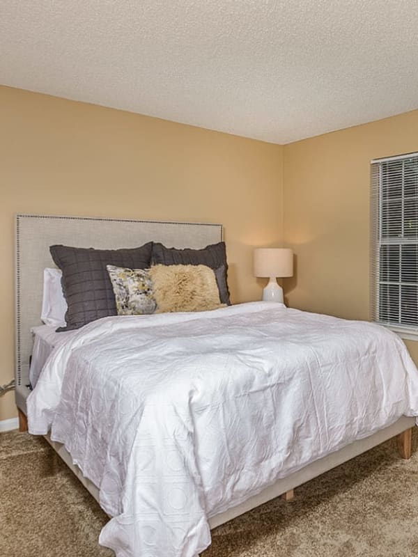 Model master bedroom with plush carpeting at Royal St. George at the Villages Apartment Homes in West Palm Beach, Florida
