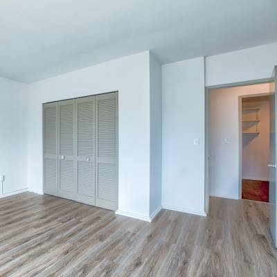 A room with wooden floor and white walls at Panorama Apartments in Seattle, Washington