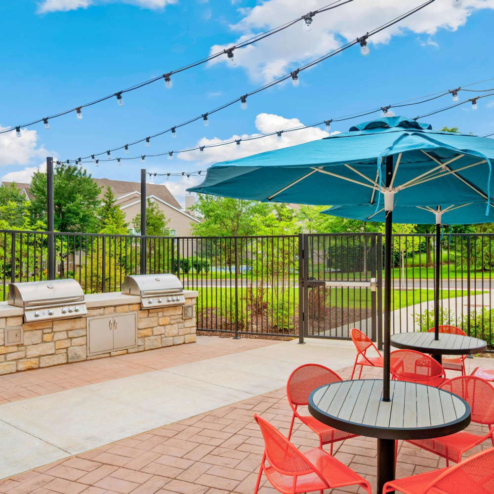 Grill station with chair and table at Neo Vantage Point in Maryland Heights, Missouri
