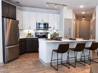 Stainless-steel appliances and granite countertops in a model home's kitchen at Shelby at Northside in Fort Worth, Texas