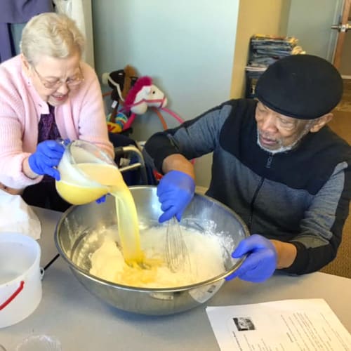 Two Residents cooking food together at Canoe Brook Assisted Living & Memory Care in Catoosa, Oklahoma