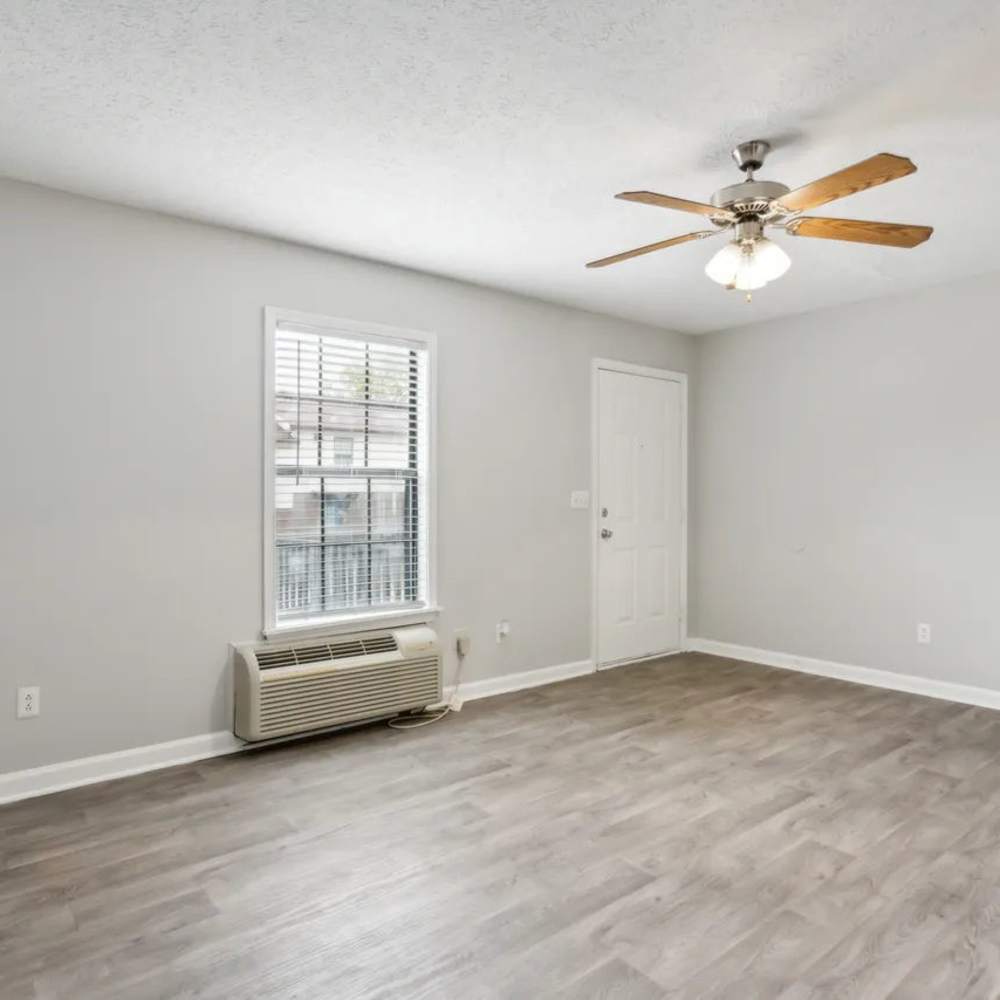 Spacious unfurnshied bedroom with air conditioner, ceiling fan and large window at The Ridge Goodletsville in Goodlettsville, Tennessee