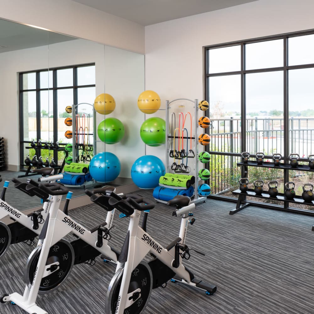 Community gym with cardio and free weights at Bellrock Market Station in Katy, Texas