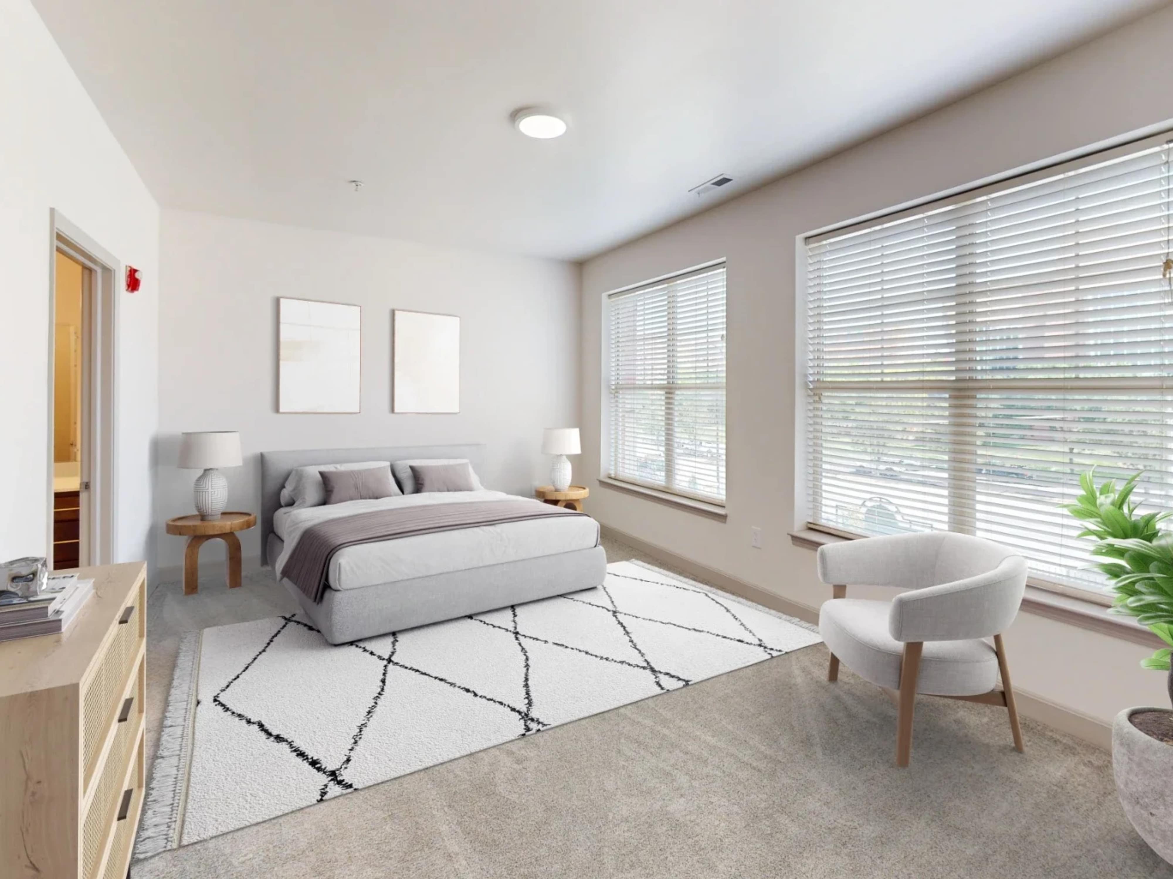 Cozy bedroom with lots of natural light at The Village at Stetson Square in Cincinnati, Ohio