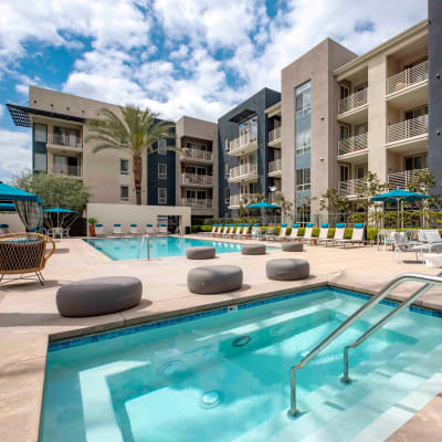 Beautifully decorated resident clubhouse interior with a billiards table and lounge seating at Sofi Warner Center in Woodland Hills, California