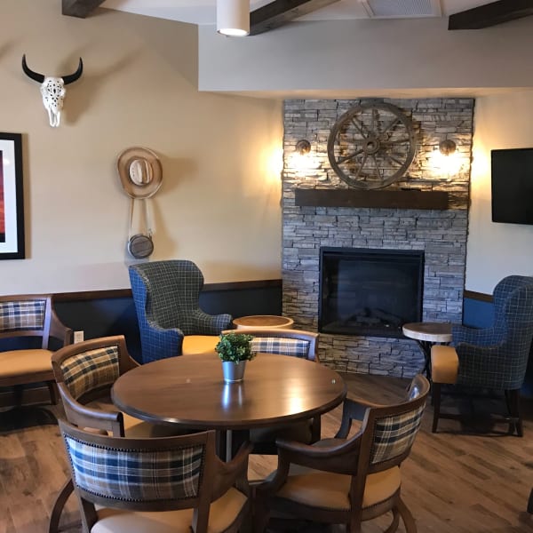 Rustic themed dining room with a fireplace at Quail Park at Shannon Ranch in Visalia, California