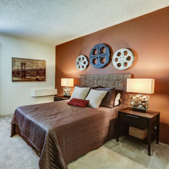 Bed and nightstand in a model home's bedroom at The Falls in Mission, Kansas