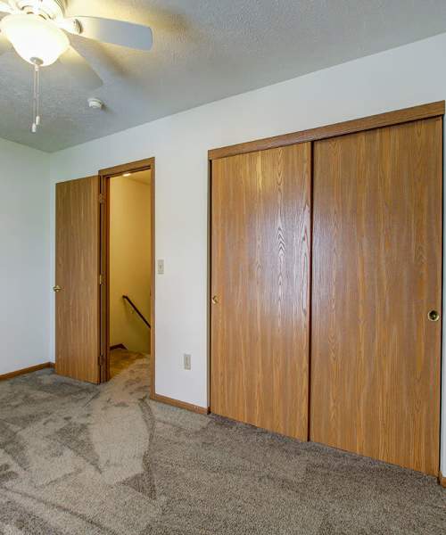 Wooden closet doors in a carpeted room at Wellington Place in Ottawa, Ohio
