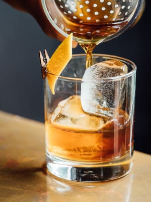 An old fashioned strained over large ice cubes at a cocktail lounge near Elevate in Englewood, Colorado