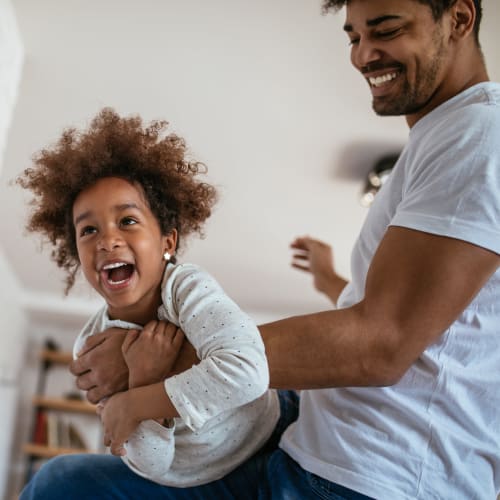 a father playing with his young kid at Terrace View Villas in San Diego, California