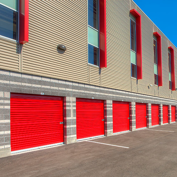 Drive-up access units with red doors at StorQuest Self Storage in North Miami, Florida