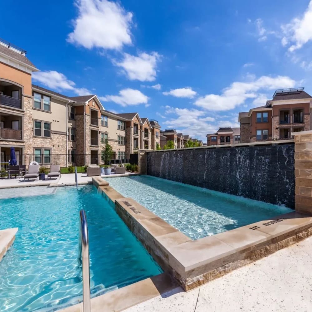 Resort-style pool with waterfall at Luxia Grand Prairie, Grand Prairie, Texas