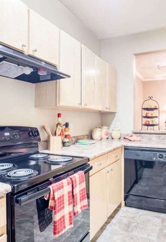 Model kitchen with light cabinetry at Villages of Cross Creek in Rogers, Arkansas