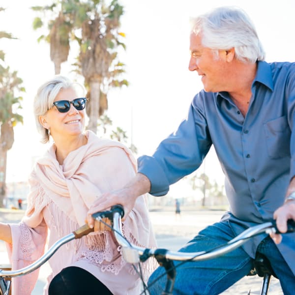 Two residents riding bikes together at Alta Vista Senior Living in Vista, California
