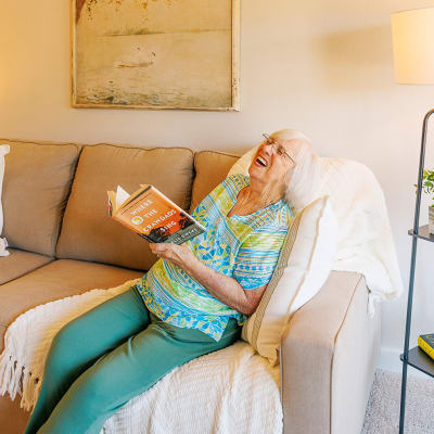 Assisted living resident smiling for a photo at Peoples Senior Living in Tacoma, Washington