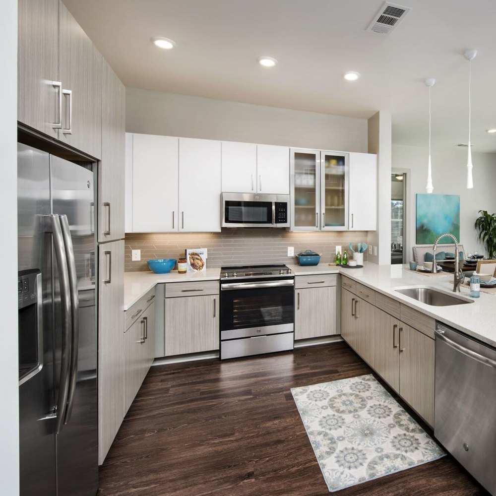 A modern kitchen with range and refrigerator at Siena Suwanee Town Center in Suwanee, Georgia