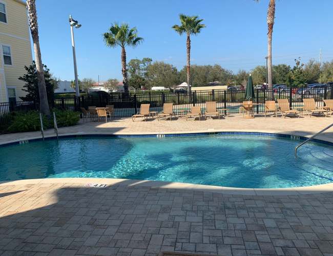 Swimming pool with lounge chairs at Journet Place in Port Richey, Florida