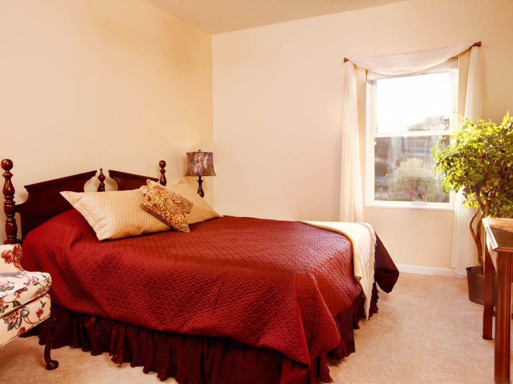 Sunlit bedroom with a large bed in it at Governor's Port in Mentor, Ohio