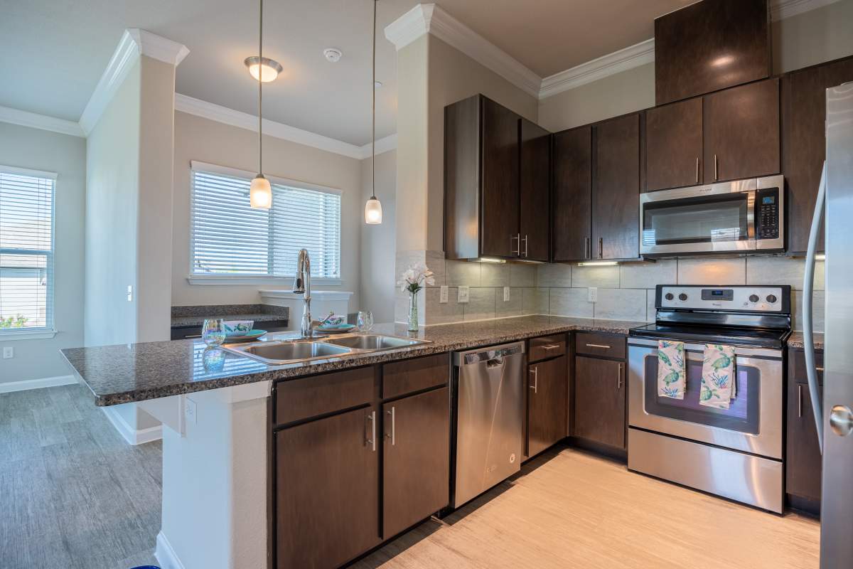 Modern kitchen with stainless-steel appliances at Century Travesia in Austin, Texas
