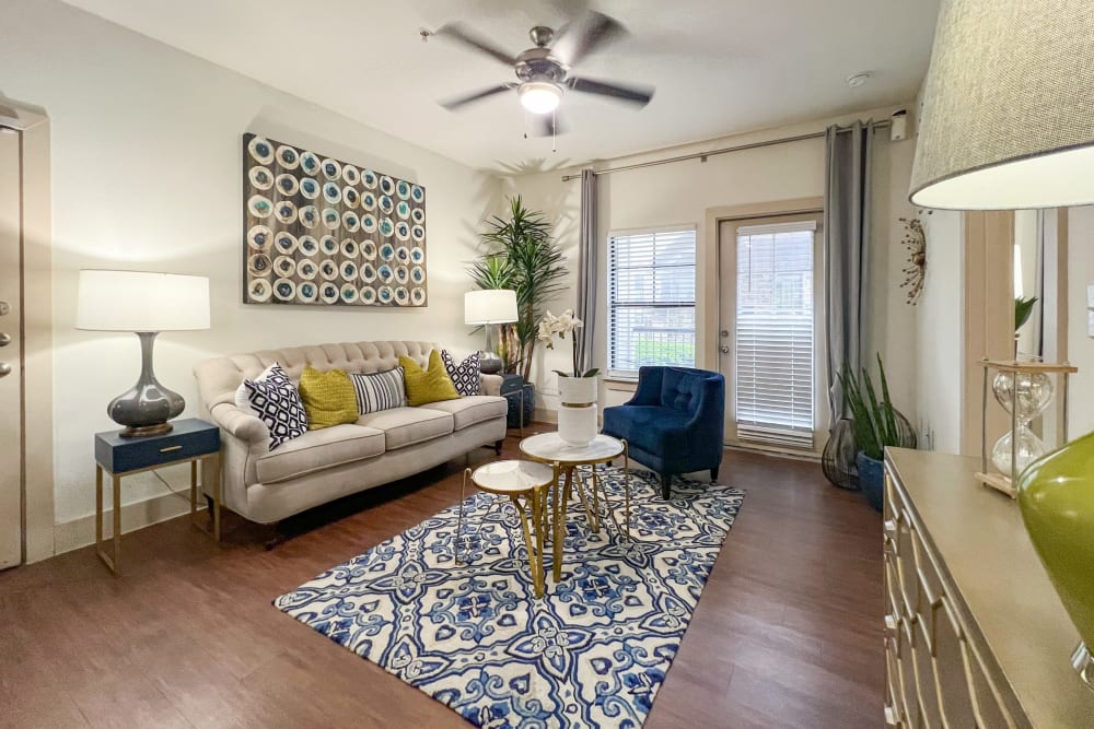 Dining room and living room with wood-style flooring at Broadstone Grand Avenue in Pflugerville, Texas