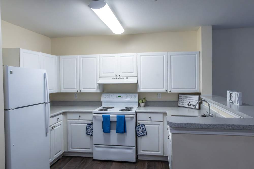 Kitchen with white appliances at Ashton Walk in Forest Park, Georgia