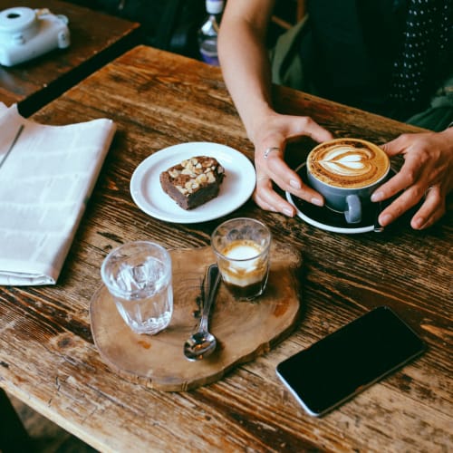 A resident enjoying coffee and a pastry near Aster, Long Beach, California