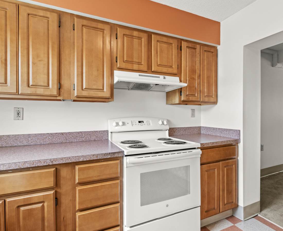Kitchen with wood cabinetries at Glenridge Gardens in Augusta, Maine