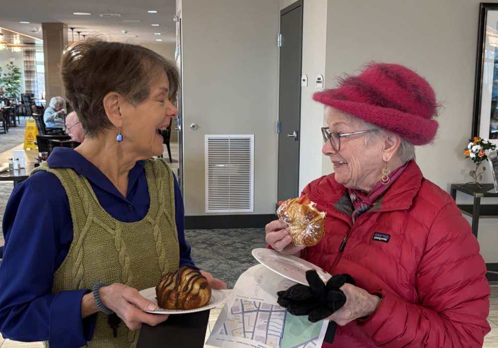 Resident friends enjoying a laugh together at Merrill Gardens at Wright Park in Tacoma, Washington