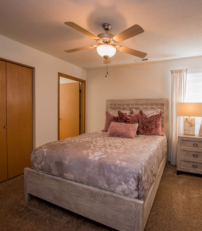 Chic bedroom with ceiling fan at Huntington Park Apartments in Wichita, Kansas
