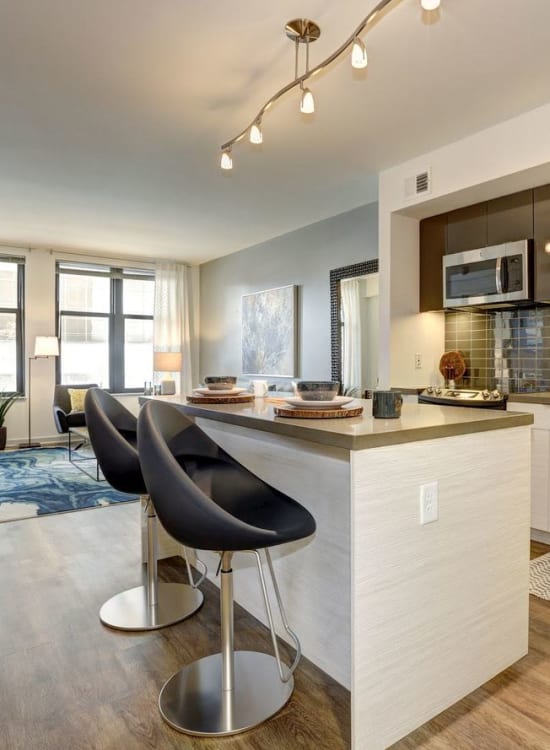 Modern kitchen with seating at Solaire 7077 Woodmont in Bethesda, Maryland